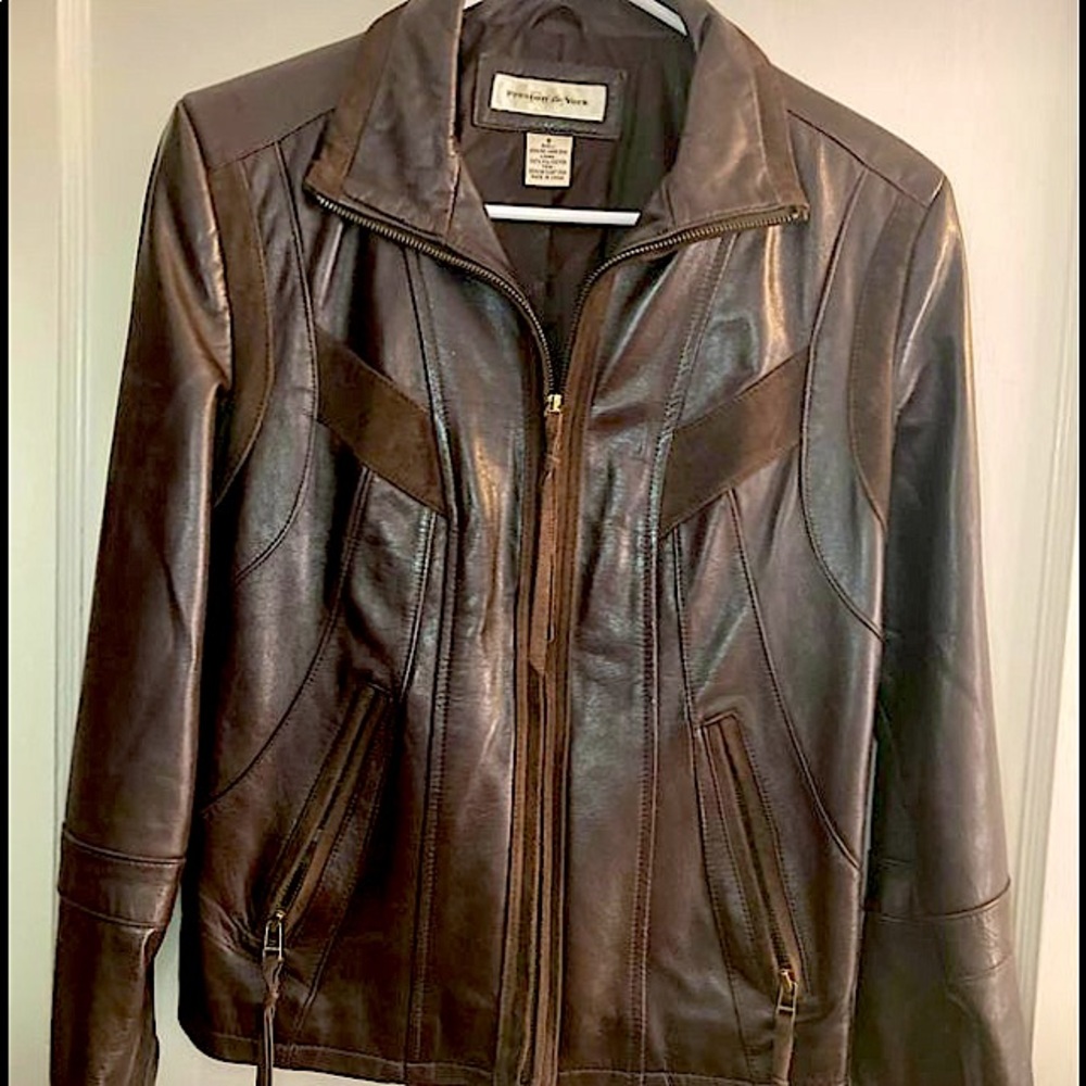 Women’s small brown leather jacket. Casual and edgy with zippers on sleeves.